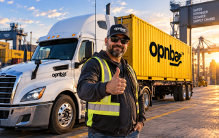 Trucker in OPNBar cap giving thumbs up beside his semi truck